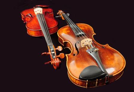 68731732-two-violins-isolated-on-black-background-music- VisitGozo